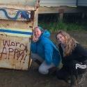 Hannah and Mackenzie posing next to a dumpster in Atqasuk.